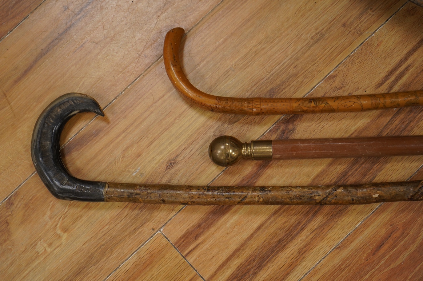 Three novelty walking sticks and gouged gathering bowl. Condition - fair